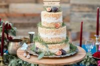 a krispie rice wedding cake with fresh figs and greenery plus a cute wooden topper is a chic rustic piece