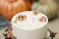 a lovely fall wedding cake with acorns