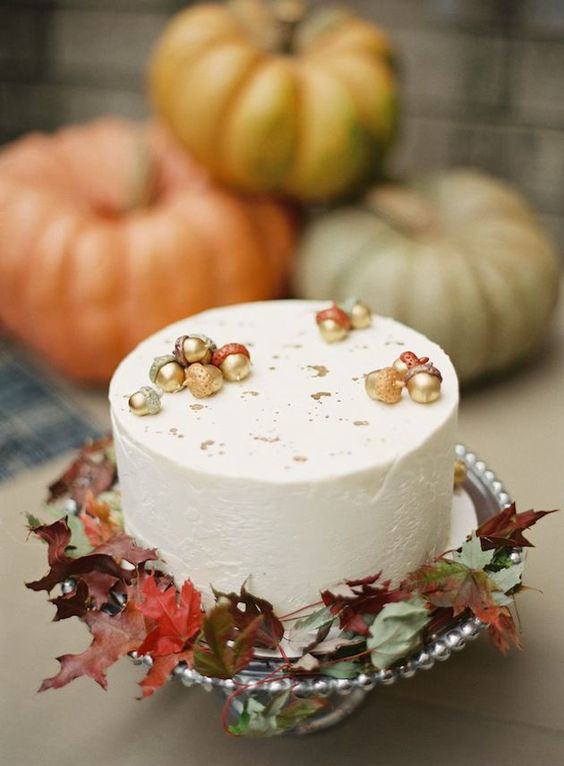 a lovely fall wedding cake with acorns