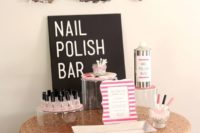 a nail polish bar with balloon letters, a sign, lots of nail polishes and all the necessary stuff