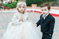 a neutral faux fur coat, a white tulle skirt, glitter shoes and a fabric headband for a winter flower girl look
