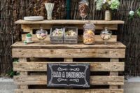 a pallet sweet wedding station stained and with a chalkboard sign is a simple rustic idea