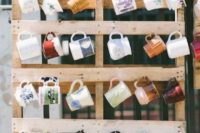 a pallet with mugs hanging is a cool idea to offer your wedding gifts