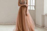 a romantic taupe wedding dress with a floral embroidery bodice and a tulle skirt with a train