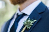 a shotgun and greenery boutonniere is a unique and creative accent to try
