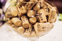 a simple and fun wedding guest book of a glass jar and wine corks is a perfect fit for a vineyard wedding