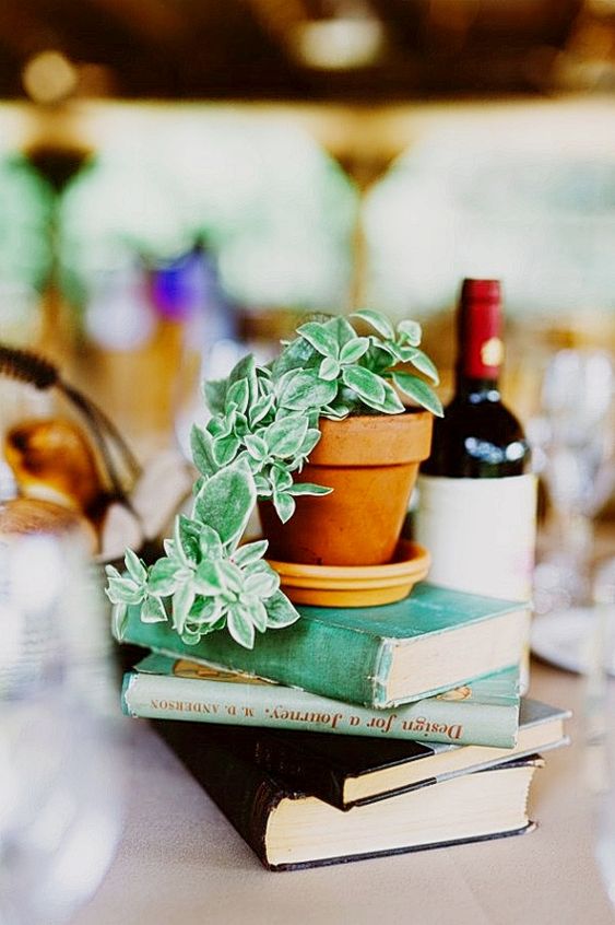 a stack of books with potted cascading greenery on top is an easy DIY idea and is very budget-friendly