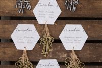 a super creative wedding seating chart of hexagons and lots of vintage keys attached is a lovely idea to recreate for a rustic wedding