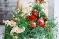 a super lush fall wedding centerpiece of greenery and ferns, blush and deep red blooms, pomegranates is a fantastic decor idea