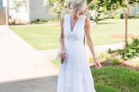 a white boho lace sleeveless midi dress with a V-neckline, nude shoes and a matching bag for a pretty and relaxed look