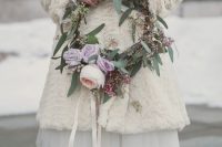 a white dress with a tutu skirt, white tights, gold shoes, a neutral faux fur coat and a flower wreath