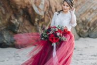 a white lace crop top with long sleeves, a bright burgundy and red tulle maxi skirt for a boho bridal look