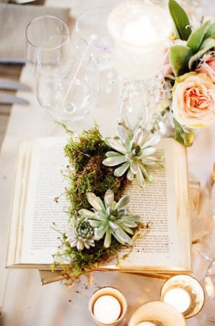 an open book with moss and succulents is a cool idea for a book lover wedding