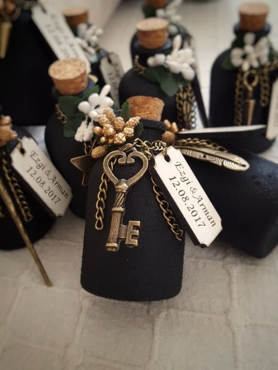 creative wedding favors - matte black bottles with chain, vintage keys, faux berries and greenery plus tags are cute for a wedding