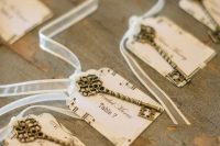 extremely beautiful vintage keys with note paper escort cards and ribbon are amazing for a vintage wedding