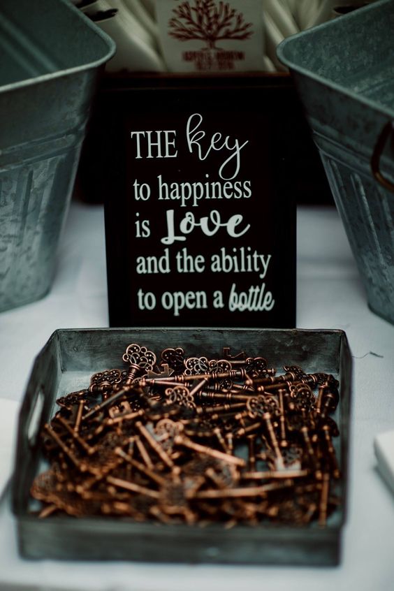 gorgeous vintage keys offered as wedding favors and a black sign are a lovely idea for a vintage or whimsical wedding