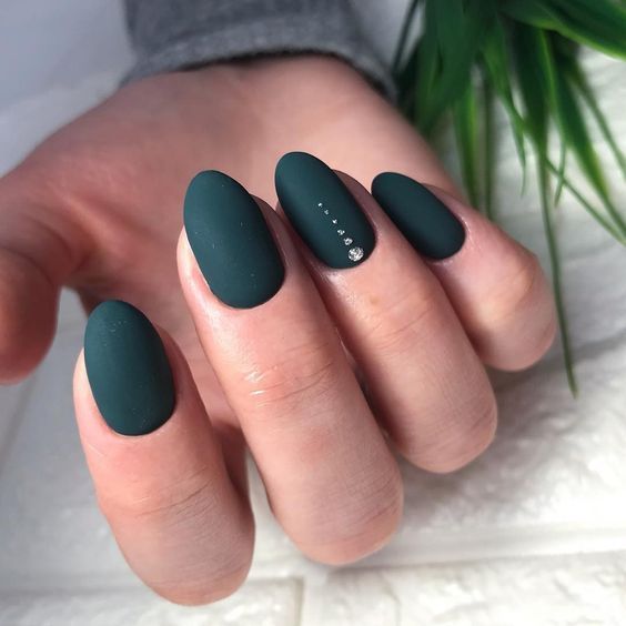 matte black nails with an accent nail with shiny dots are bold and chic and will match many bridal looks