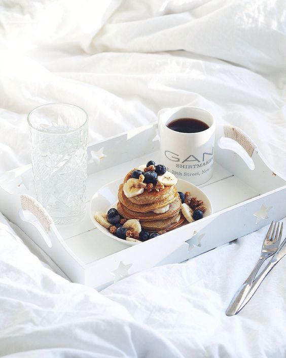 pancakes with bananas and blueberries and a mug of coffee is a delicious and nutricious breakfast gift
