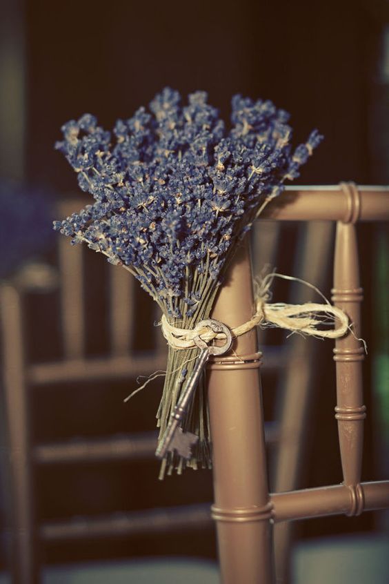 wedding aisle decor - a chair accented with lavender and a vintage key is a lovely idea for a rustic wedding