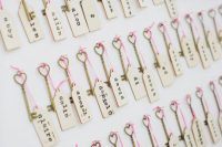 wedding escort cards with matching gold vintage keys with hearts and pink twine are amazing for a romantic wedding