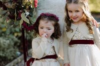 whimsy dresses with gold sequin bodices, white lace skirts, neutral cardigans and burgundy velvet sashes