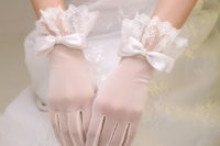 white tulle gloves with delicate lace edges and silk bows with pearls for a romantic and chic look