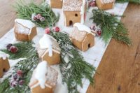 a Christmas wedding centerpiece or table runner composed of gingerbread cookies, evergreens and sugared berries is a gorgeous DIY