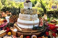 a cheese tower for a tropical wedding displayed with fresh fruit, berries and crackers is a gorgeous idea