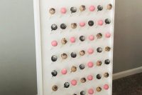 a colorful cake pop wall with gold calligraphy is a lovely idea for a modern wedding, food walls are on trend