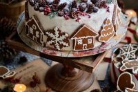 a fantastic white gingerbread wedding cake decorated with gingerbread cookies, with pinecones, berries and evergreens for a Christmas wedding