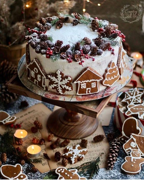 a fantastic white gingerbread wedding cake decorated with gingerbread cookies, with pinecones, berries and evergreens for a Christmas wedding