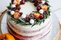 a frosty wedding cake topped with rosemary, sugar snowballs, citrus and berries looks very stylish