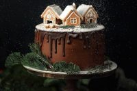 a gingerbread wedding cake with chocolate buttercream, chocolate drip, gingerbread houses and evergreens is a lovely idea for a winter wedding
