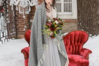 a grey winter bridal look with a romantic dress with an A-line skirt, an embellished bodice and a fringe coverup
