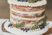 a naked wedding cake with greenery and blueberries is a lovely idea for a woodland or rustic wedding