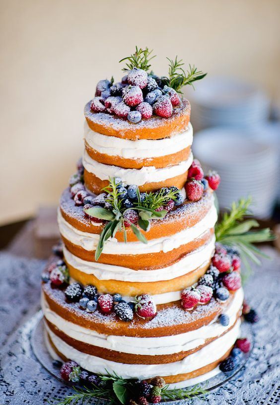 a naked wedding cake with greenery and sugared berries is a perfect option not only for a winter wedding
