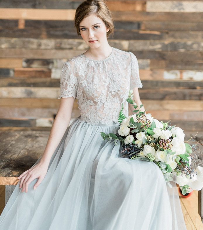 a romantic and chic bridal separate of a dove grey lace crop top with a high neckline and a plain layered skirt