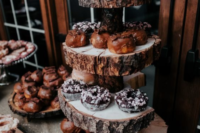 a rustic winter dessert table with a wood slice stand that brings a cozy and intimate feeling to the space