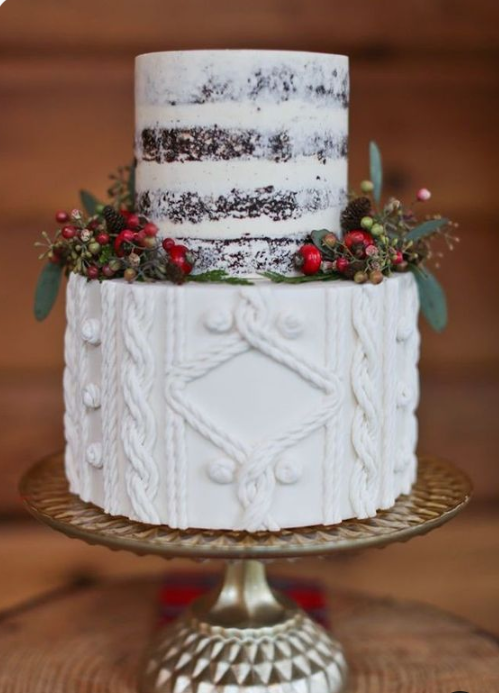 a rustic winter wedding cake with a naked and a sweater-inspired tier, berries and greenery on a glam metallic stand