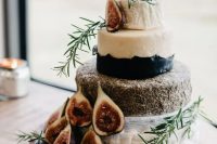 a small and pretty cheese wheel wedding cake topped with fresh figs, honey combs and herbs is a lovely idea for a refined decadent wedding