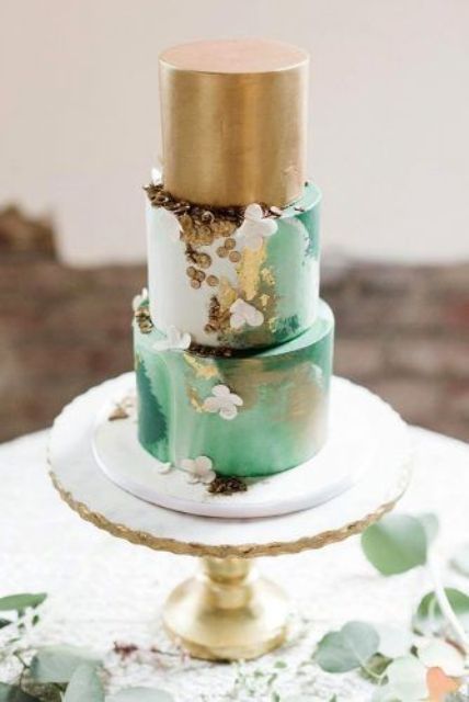 a statement gold, white and green watercolor wedding cake with gold polka dots and white sugar blooms for a summer wedding