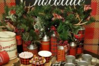 a sweet and cozy hot chocolate bar with plaid touches, an evergreen and berry arrangement with antlers and metal mugs