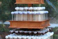 a tiered wooden stand with various cake pops is a lovely alternative to a wedding cake or an addition to it