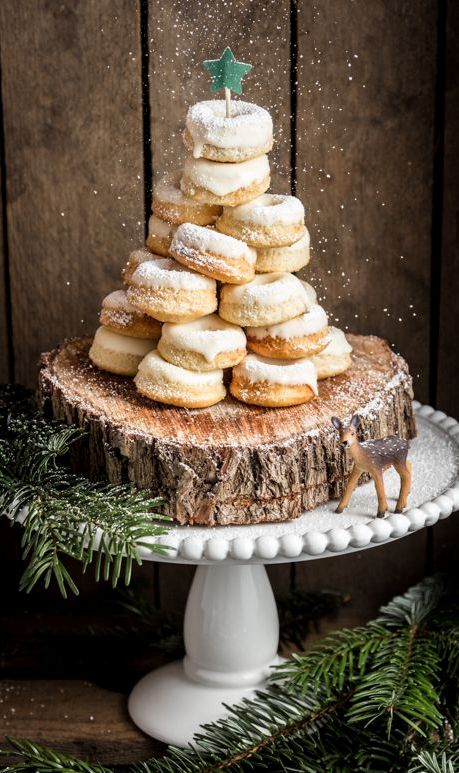 a wood slice holding a stack of gingerbread donuts with glazing and a green star topper is a gorgeous idea for winter or Christmas