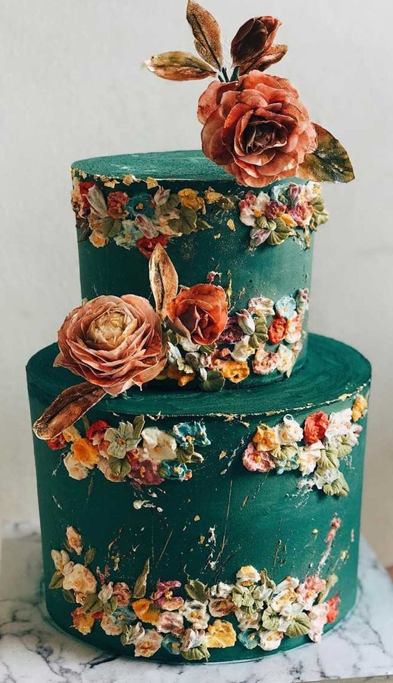 an artsy green wedding cake with sugar blooms that remind of Impressionism and bold blooms on top is breathtaking