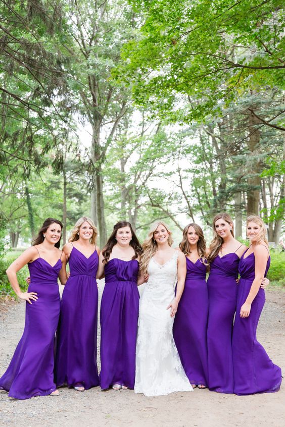 bold violet maxi bridesmaid dresses with draped bodices and spaghetti straps and short trains are super chic