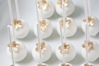 elegant white and gold flower cake pops are amazing for a modern wedding with a refined gold and white color scheme