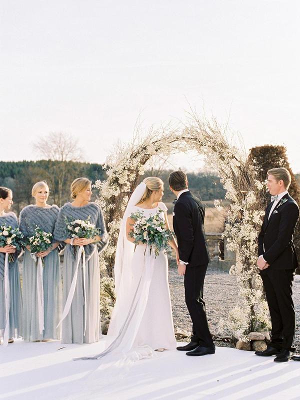 grey maxi bridesmaid dresses paired up with geometric faux fur coverups are a very romantic and stylish combo