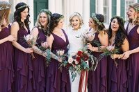 lovely purple maxi bridesmaid dresses with thick straps, deep V-necklines and ruffle skirts plus greenery crowns for a bold fall wedding