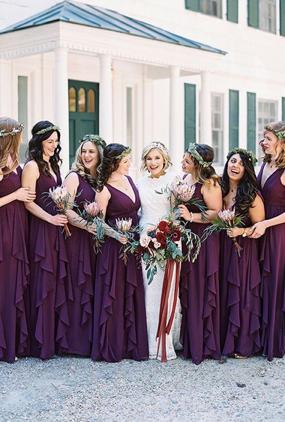 lovely purple maxi bridesmaid dresses with thick straps, deep V-necklines and ruffle skirts plus greenery crowns for a bold fall wedding